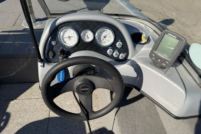 Slide: The Image of 2010 Tracker Pro Guide V-16 WT boat dashboard with gauges and Lowrance fish finder. - 9