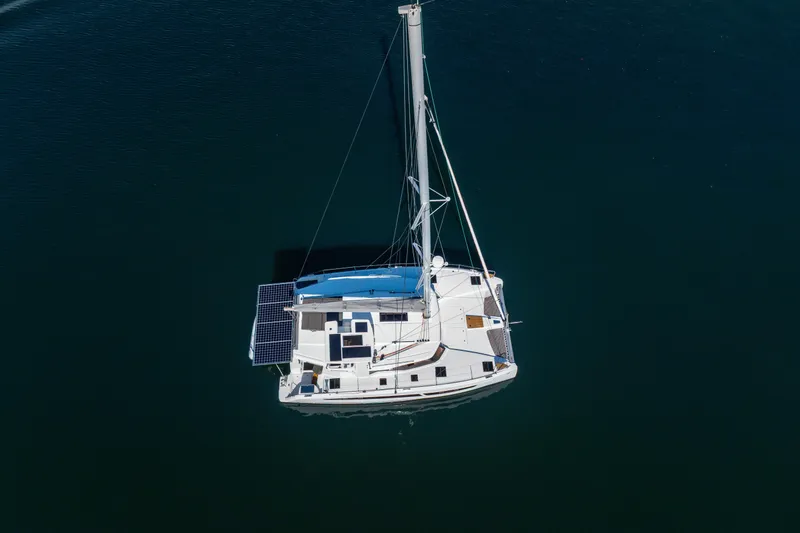 Slide: The Image of Aerial view of 2025 Fountaine Pajot FP41 Catamaran with solar panels on calm water. - 11