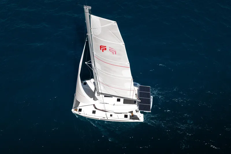 Slide: The Image of 2025 Fountaine Pajot FP41 Catamaran sailing on open blue sea. - 14