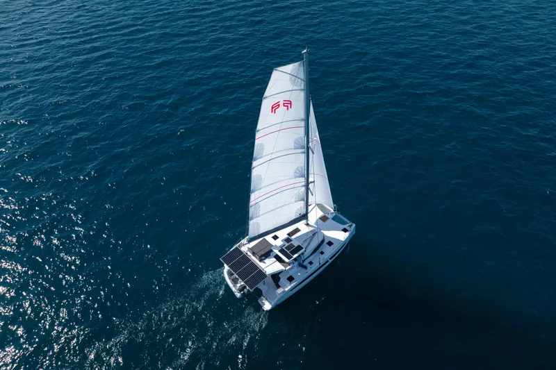 Slide: The Image of 2025 Fountaine Pajot FP41 Catamaran sailing on open blue sea. - 21