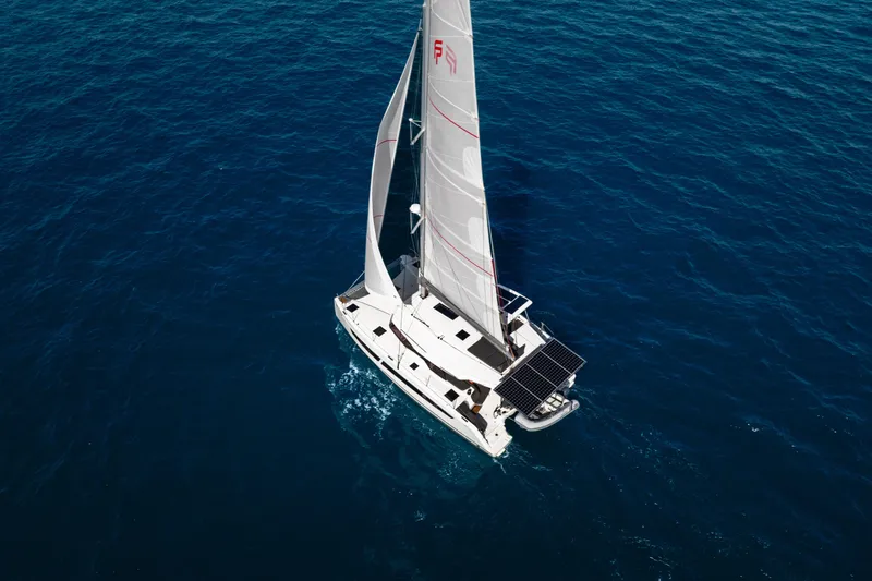 Slide: The Image of 2025 Fountaine Pajot FP41 Catamaran sailing on open blue sea, aerial view. - 22