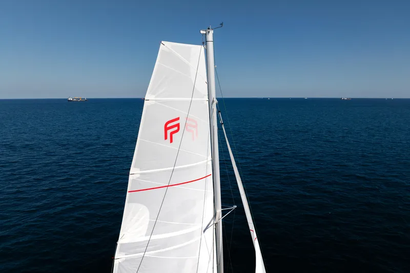 Slide: The Image of 2025 Fountaine Pajot FP41 Catamaran sailing on open sea under clear blue sky. - 23