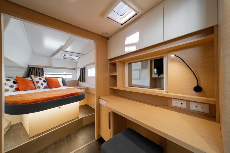 Slide: The Image of Luxurious interior of 2025 Fountaine Pajot FP41 Catamaran with modern bedroom and workspace. - 28