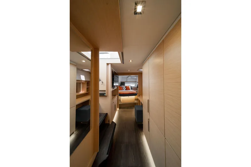 Slide: The Image of Interior of 2025 Fountaine Pajot FP41 Catamaran, featuring modern wood finishes and cozy cabin. - 29