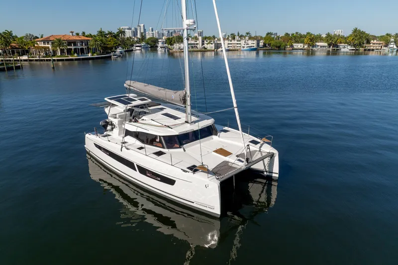 Slide: The Image of 2025 Fountaine Pajot FP41 Catamaran sailing in a serene marina setting. - 3