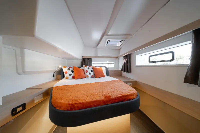 Slide: The Image of Luxurious bedroom interior of 2025 Fountaine Pajot FP41 Catamaran with modern design and orange accents. - 30