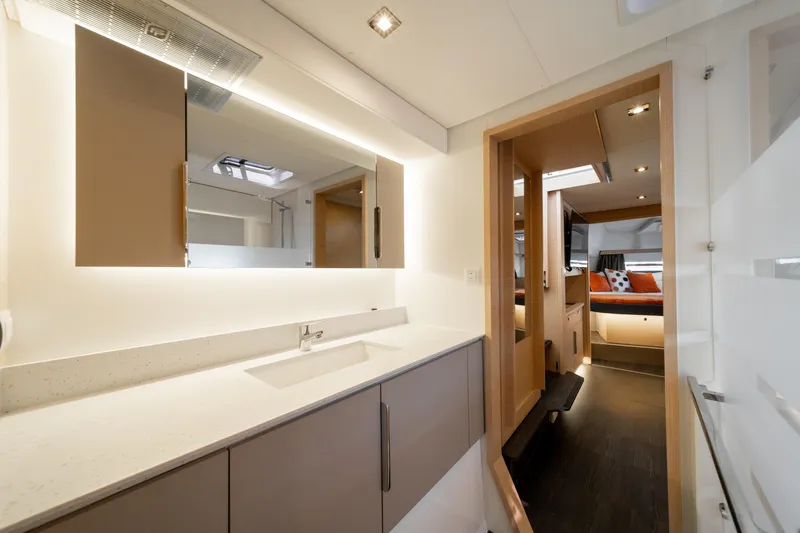 Slide: The Image of Luxurious interior of 2025 Fountaine Pajot FP41 Catamaran, featuring modern bathroom and cozy cabin. - 31