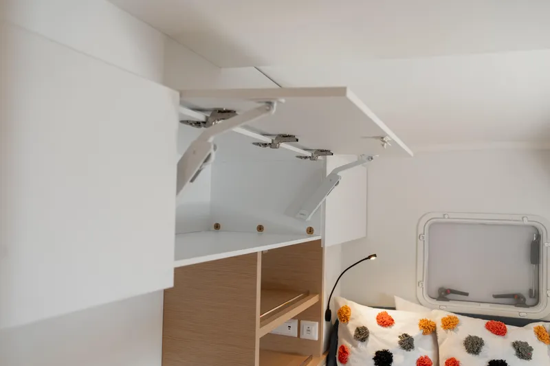 Slide: The Image of Interior of 2025 Fountaine Pajot FP41 Catamaran with open storage and cozy bedding. - 43