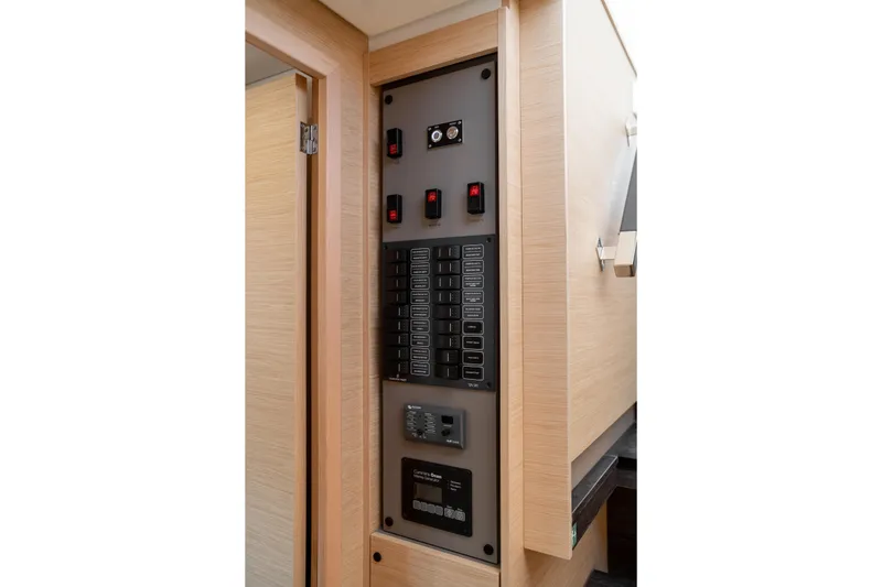 Slide: The Image of Electrical panel inside 2025 Fountaine Pajot FP41 Catamaran, featuring switches and controls. - 44
