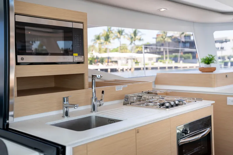 Slide: The Image of Modern kitchen interior of 2025 Fountaine Pajot FP41 Catamaran with stove and microwave. - 52