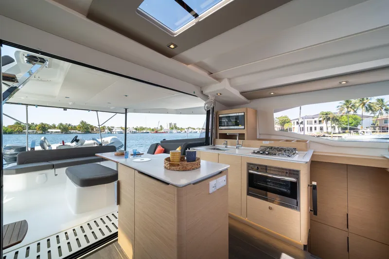 Slide: The Image of Luxurious interior of 2025 Fountaine Pajot New 41 catamaran with modern kitchen and scenic view. - 54