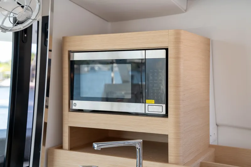 Slide: The Image of Modern kitchen area on 2025 Fountaine Pajot FP41 Catamaran with built-in microwave. - 57