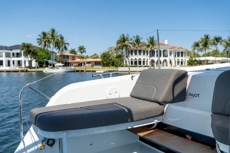 Slide: The Image of 2025 Fountaine Pajot FP41 Catamaran with luxurious seating, docked near waterfront homes. - 60