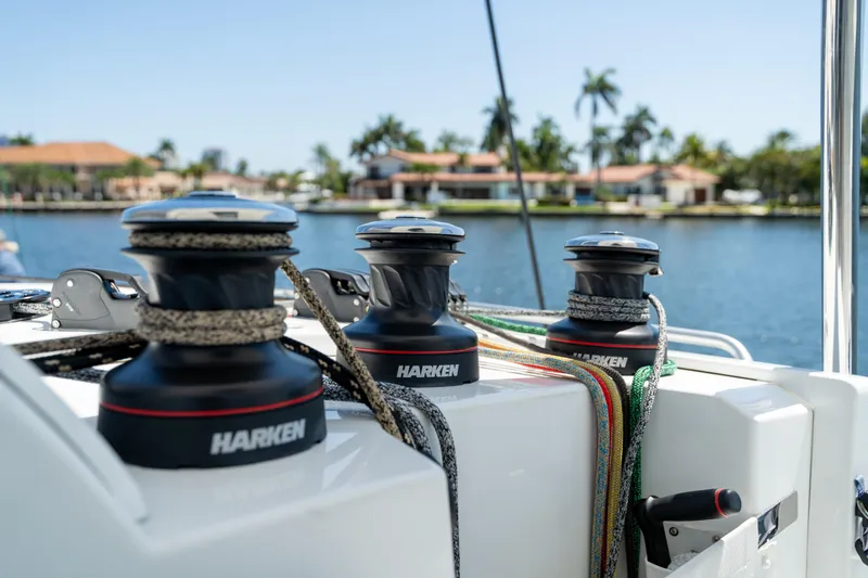 Slide: The Image of Winches on 2025 Fountaine Pajot FP41 Catamaran, docked by waterfront homes. - 64