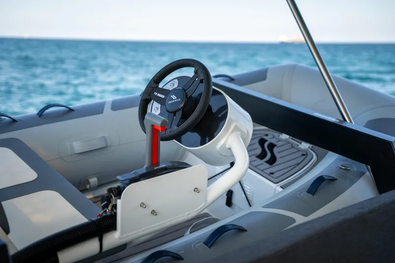 Slide: The Image of Steering wheel of 2025 Fountaine Pajot FP41 Catamaran, ocean in background. - 68