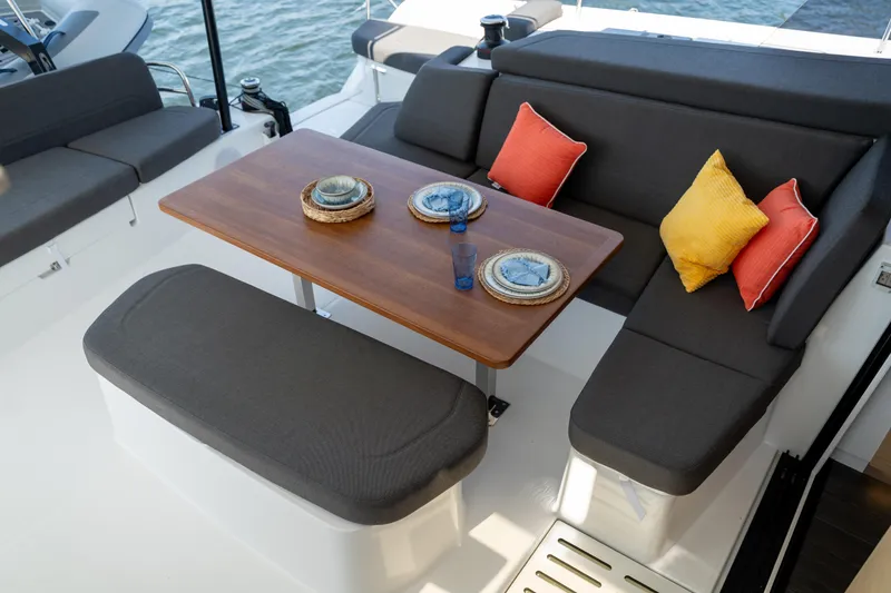 Slide: The Image of Outdoor seating area on 2025 Fountaine Pajot New 41 yacht with cushions and tableware. - 75