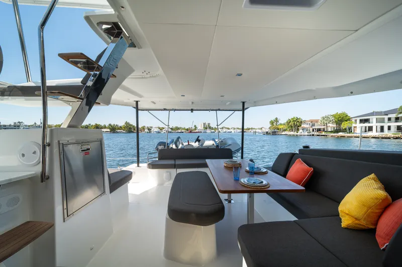 Slide: The Image of Luxurious 2025 Fountaine Pajot New 41 yacht interior with elegant seating and scenic waterfront view. - 76