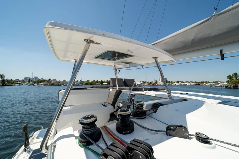 Slide: The Image of 2025 Fountaine Pajot New 41 catamaran helm station with winches, overlooking marina. - 77