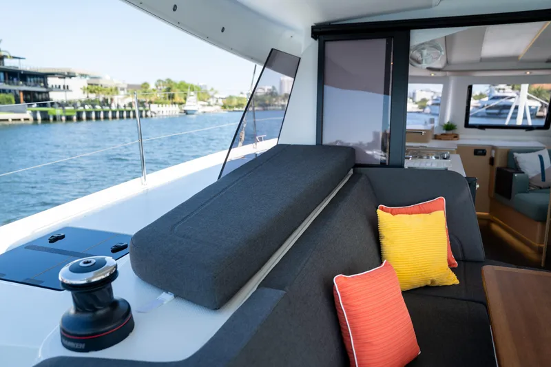Slide: The Image of Luxurious interior of 2025 Fountaine Pajot New 41 catamaran with colorful cushions and waterfront view. - 82