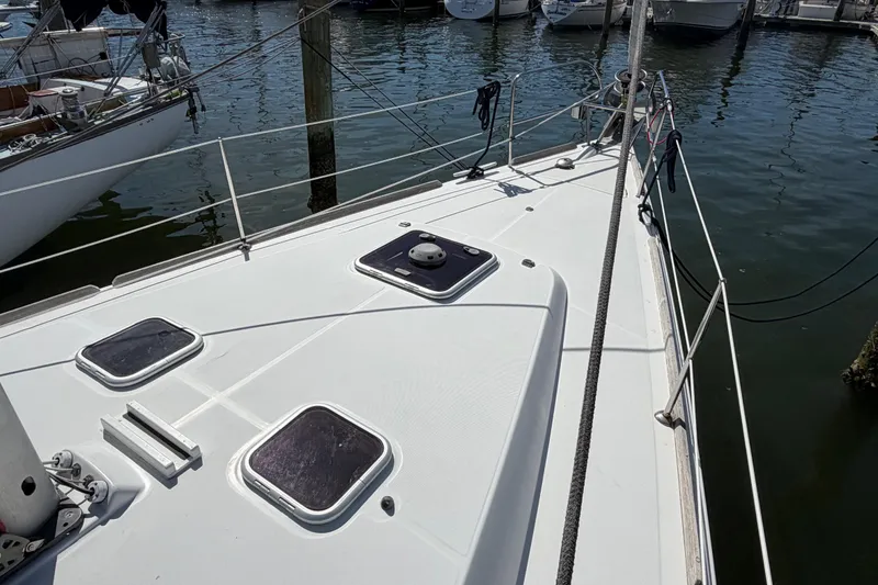 Slide: The Image of Deck view of a 2008 Beneteau 43 sailboat docked at a marina. - 11