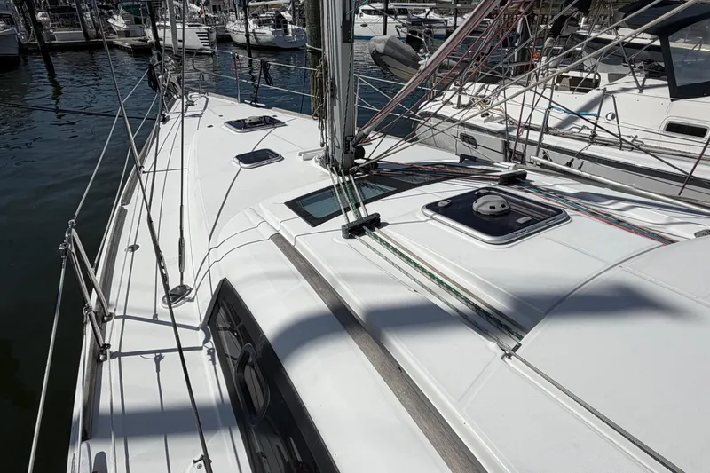 Slide: The Image of Deck view of a 2008 Beneteau 43 sailboat in a marina. - 13