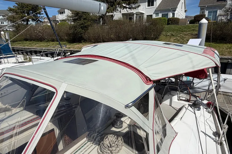 Slide: The Image of 2008 Beneteau 43 sailboat with covered cockpit, docked in a marina setting. - 14