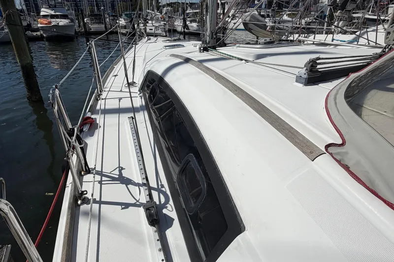 Slide: The Image of 2008 Beneteau 43 sailboat deck view at marina, showcasing sleek design and rigging. - 15