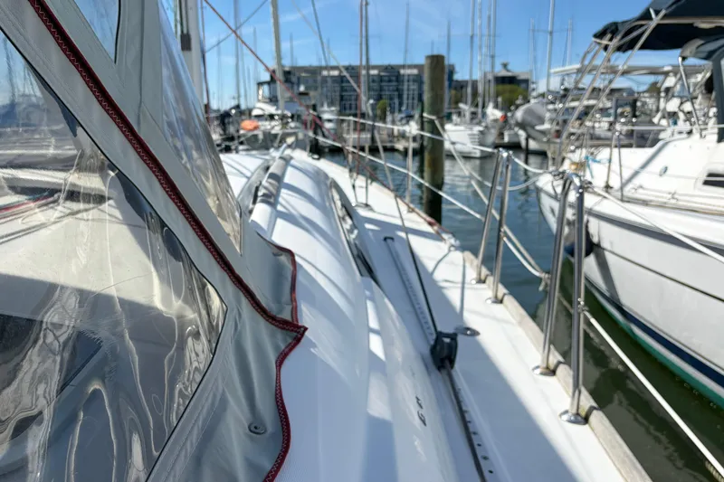 Slide: The Image of 2008 Beneteau 43 sailboat docked in marina, showcasing sleek design and rigging. - 16