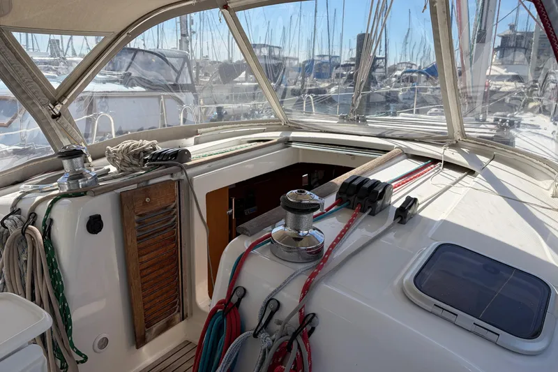 Slide: The Image of Cockpit of a 2008 Beneteau 43 sailboat with ropes and winches in a marina. - 17