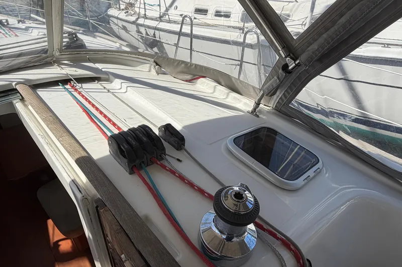 Slide: The Image of 2008 Beneteau 43 yacht deck with winch and colorful ropes under canopy. - 20
