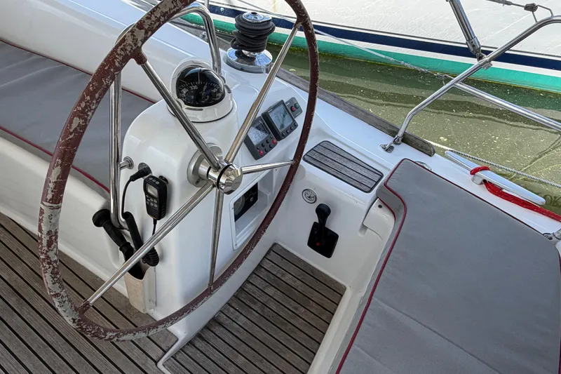 Slide: The Image of Steering wheel and cockpit of a 2008 Beneteau 43 sailboat, featuring navigation instruments. - 24