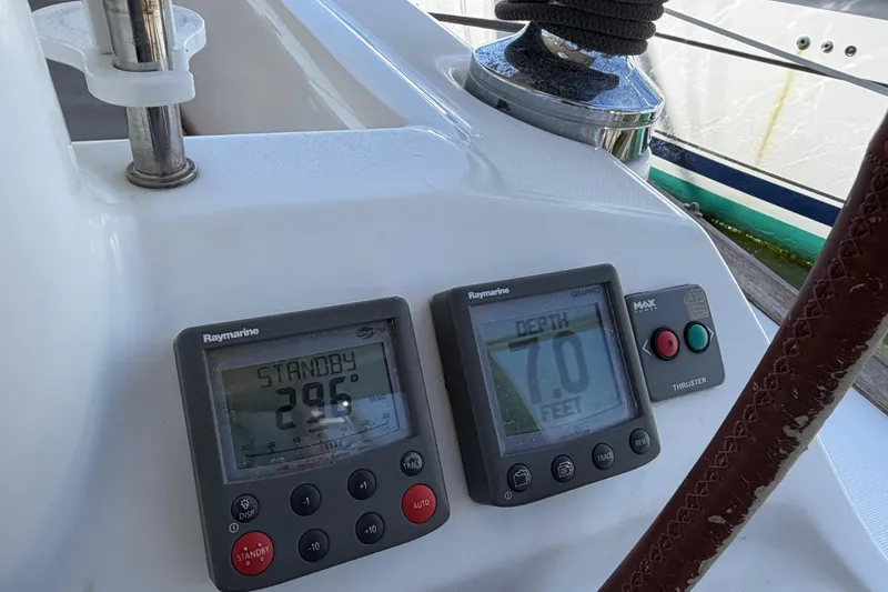 Slide: The Image of Beneteau 43 yacht dashboard with Raymarine instruments, showing 296° heading and 7.0 feet depth. - 26
