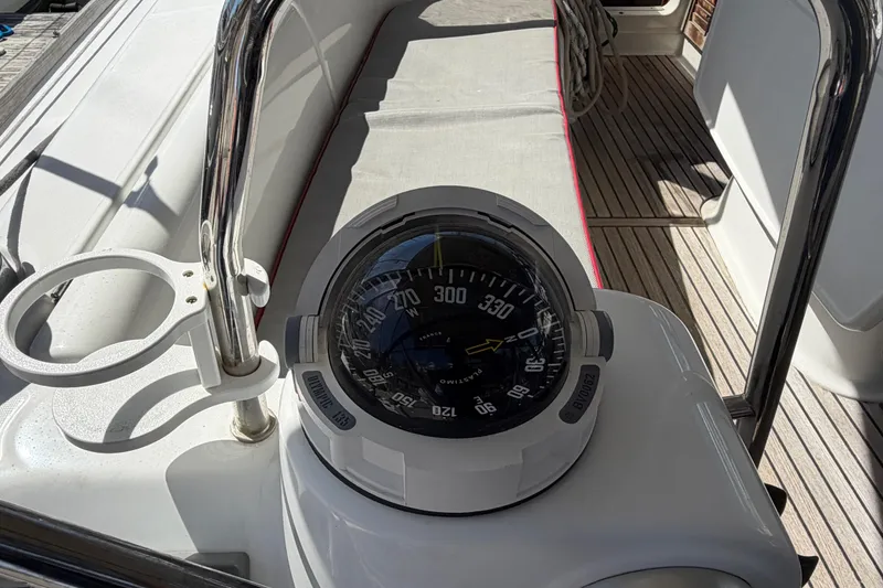 Slide: The Image of Compass on deck of 2008 Beneteau 43 sailboat, with teak flooring and stainless steel railing. - 31