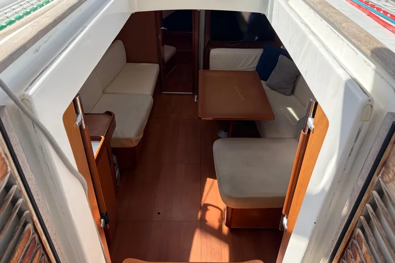 Slide: The Image of Interior view of 2008 Beneteau 43 sailboat, featuring cozy seating and wooden table. - 33