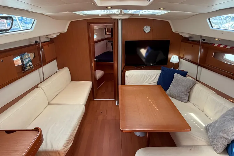 Slide: The Image of Interior of 2008 Beneteau 43 yacht with cozy seating, wooden table, and modern decor. - 34