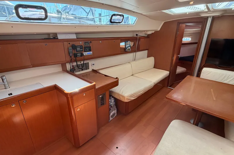 Slide: The Image of Interior of a 2008 Beneteau 43 yacht with wood finish and seating area. - 35