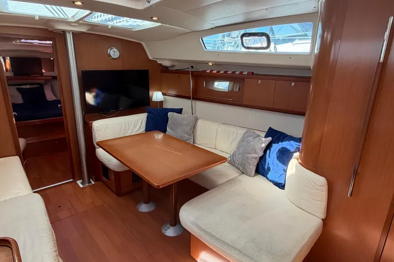 Slide: The Image of Interior of 2008 Beneteau 43 yacht with cozy seating, table, and TV. - 36