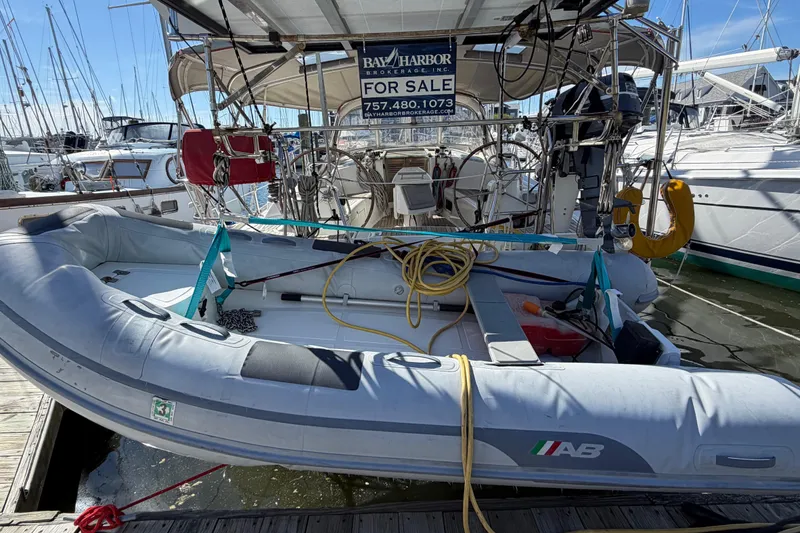 Slide: The Image of Beneteau 43 sailboat from 2008 with dinghy, docked and for sale. - 4