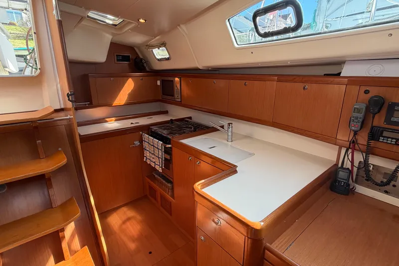 Slide: The Image of Interior of 2008 Beneteau 43 yacht kitchen with wood cabinetry and modern appliances. - 40