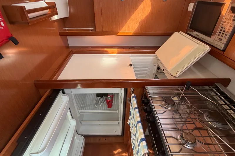 Slide: The Image of Galley kitchen in 2008 Beneteau 43 yacht with stove, fridge, and microwave. - 42