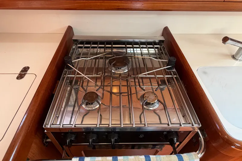 Slide: The Image of Galley stove on 2008 Beneteau 43 yacht, featuring three burners and stainless steel finish. - 47