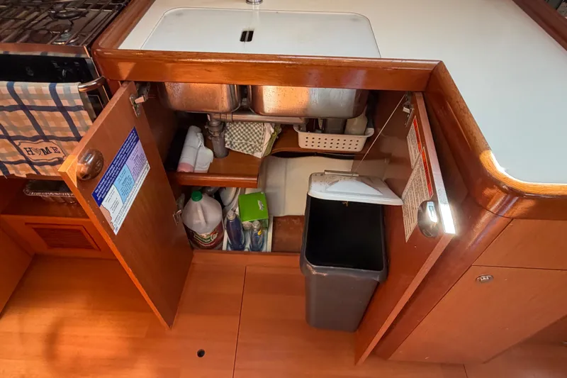 Slide: The Image of Interior view of a 2008 Beneteau 43 kitchen sink area with open cabinets. - 51