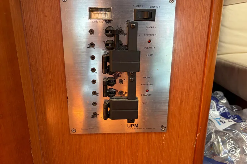 Slide: The Image of Electrical panel on a 2008 Beneteau 43 yacht, featuring switches and voltage meter. - 54