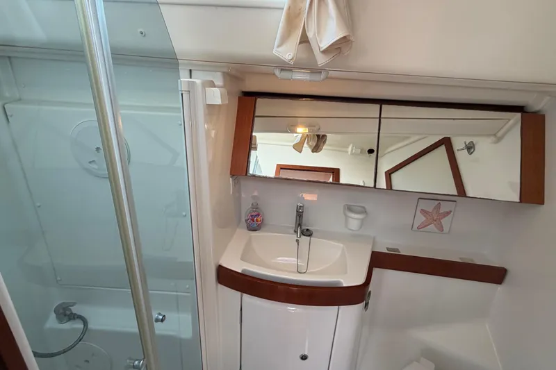 Slide: The Image of Bathroom interior of 2008 Beneteau 43 yacht with sink, mirror, and shower. - 56