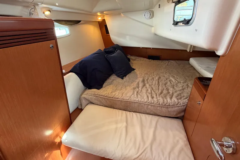 Slide: The Image of Cozy cabin interior of 2008 Beneteau 43 sailboat with bed and wooden furnishings. - 59