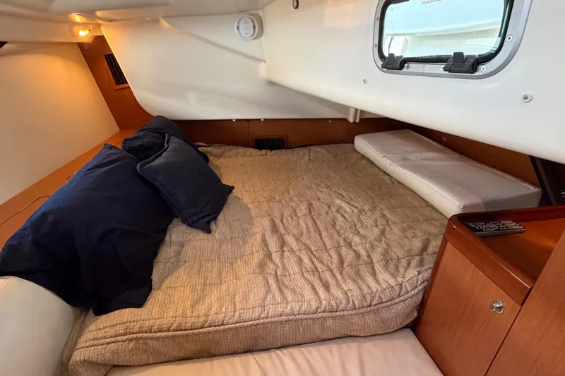 Slide: The Image of Cozy cabin interior of 2008 Beneteau 43 sailboat with bed and porthole. - 60
