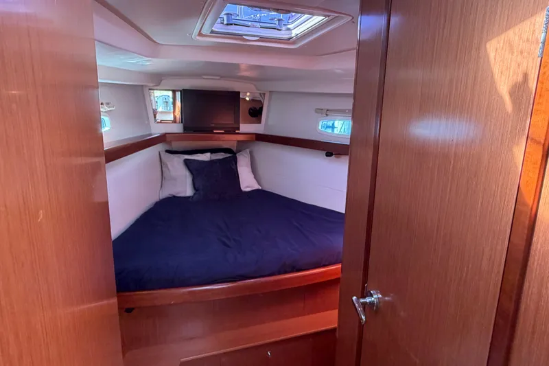 Slide: The Image of Cozy cabin interior of 2008 Beneteau 43 yacht with bed and portholes. - 61