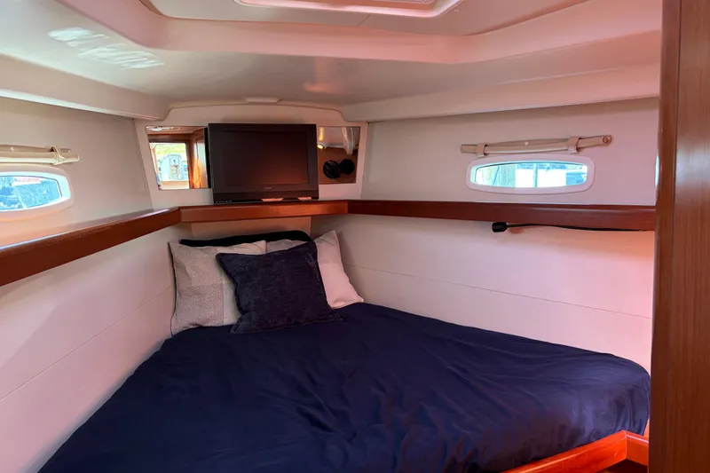 Slide: The Image of Cozy cabin interior of 2008 Beneteau 43 yacht with bed and TV. - 62