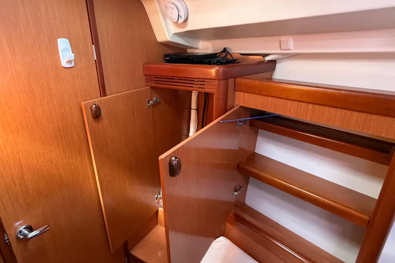 Slide: The Image of Interior of 2008 Beneteau 43 yacht showing wooden cabinetry and open storage compartments. - 64