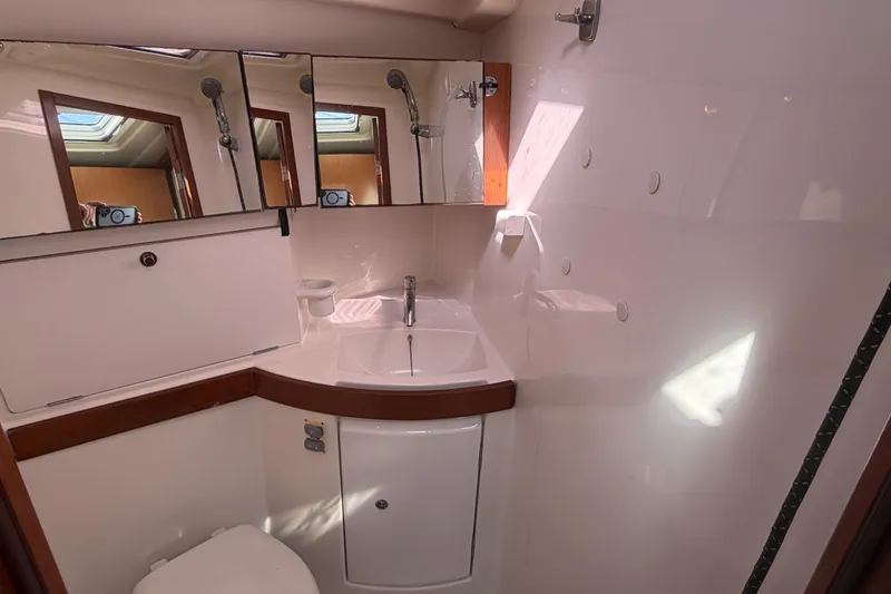 Slide: The Image of Bathroom interior of 2008 Beneteau 43 yacht with sink, mirror, and shower. - 65